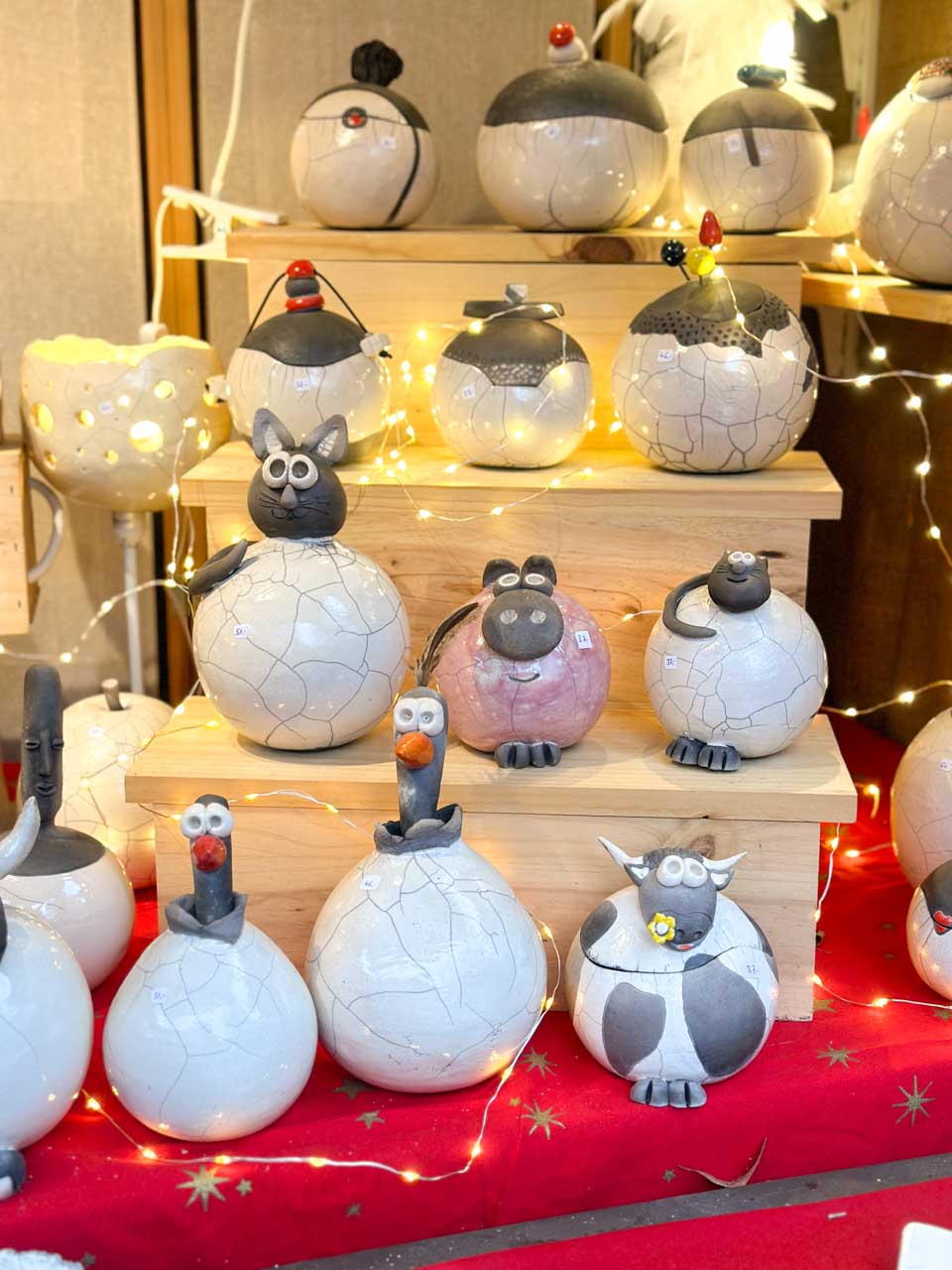 Quirky ceramic animal figures at a Colmar Christmas market stall