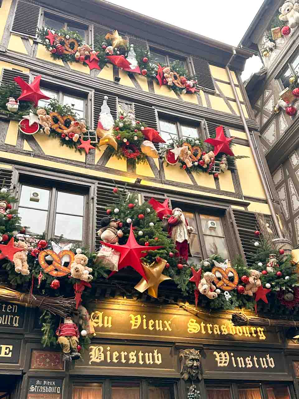A traditional Strasbourg eatery, Au Vieux Strasbourg, adorned with Christmas wreaths and stars