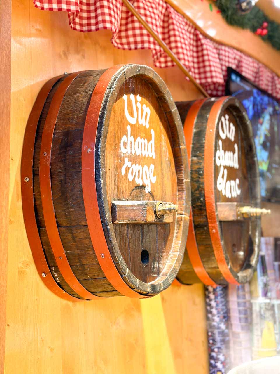 Wooden barrels labelled Vin chaud rouge and Vin chaud blanc at the Place du Château Christmas market in Strasbourg
