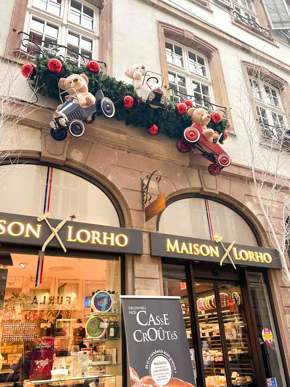 The façade of Maison Lorho in Strasbourg adorned with teddy bears and festive ornaments