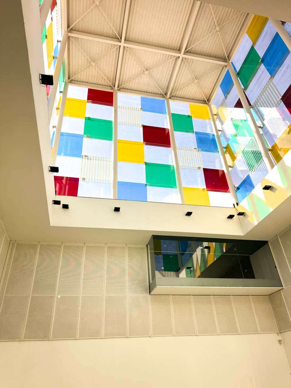 Multi-coloured glass panels of the Centre Pompidou building in Malaga seen from the inside