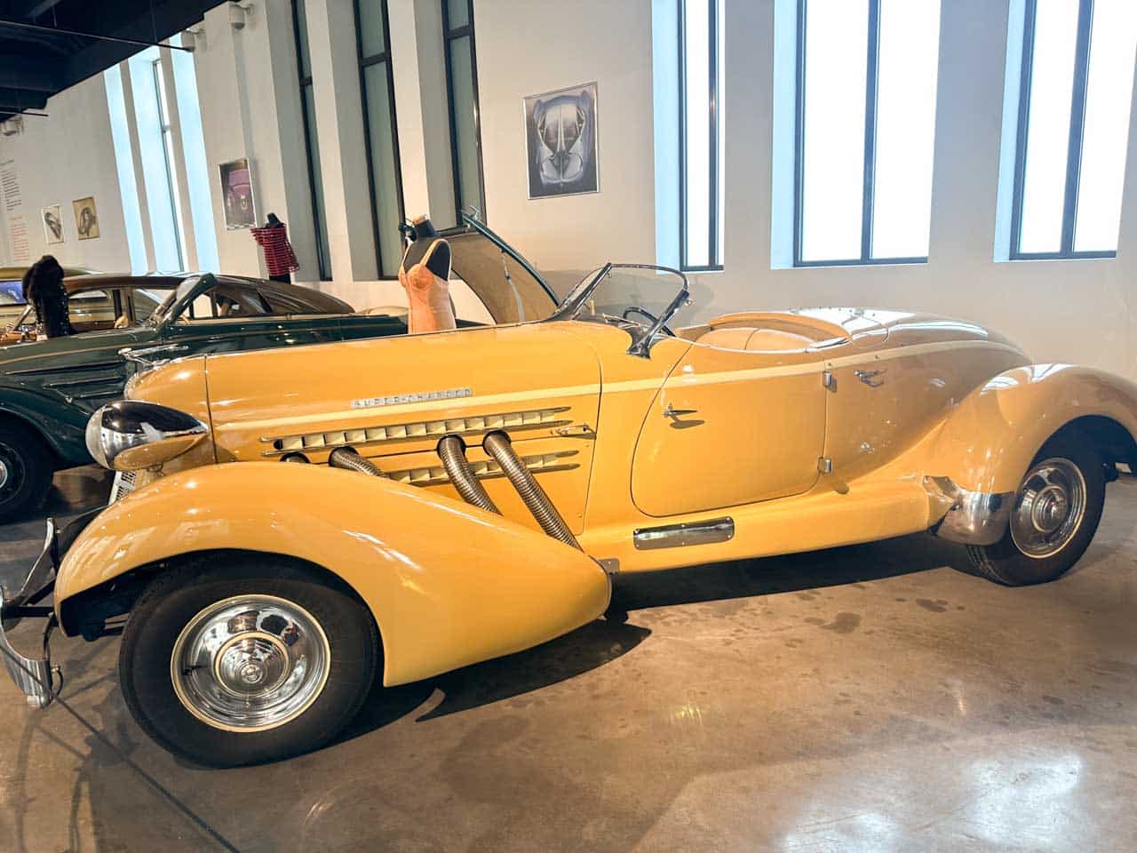 A vintage yellow Auburn Speedster convertible displayed at the Automobile and Fashion Museum in Malaga, Spain