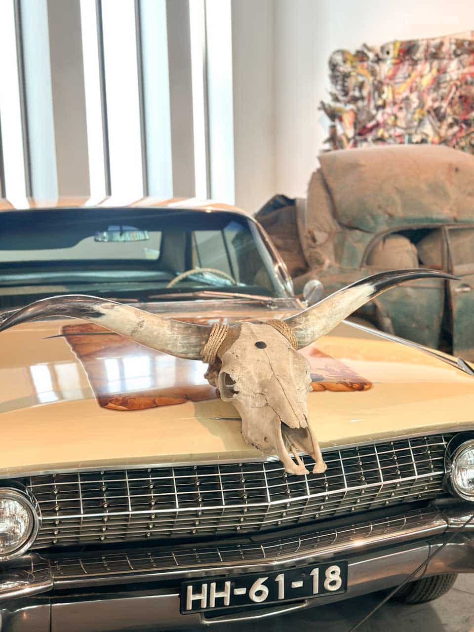 A classic car with a steer skull mounted on the bonnet at the Automobile and Fashion Museum in Malaga, Spain