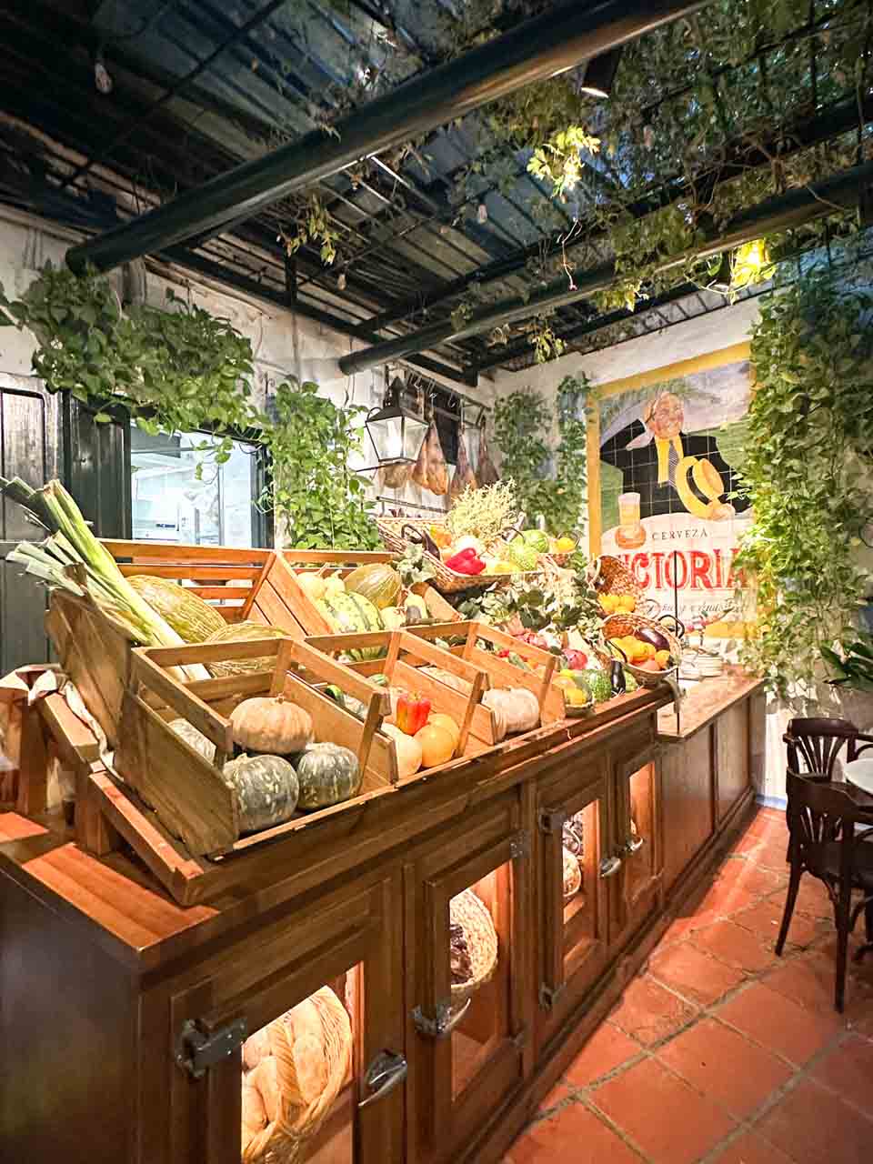 Wooden crates filled with fresh vegetables at Bodega El Pimpi in Malaga, Spain