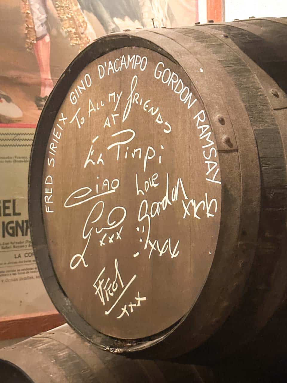 A close-up of a wine barrel signed by Gordon Ramsay at Bodega El Pimpi in Malaga, Spain