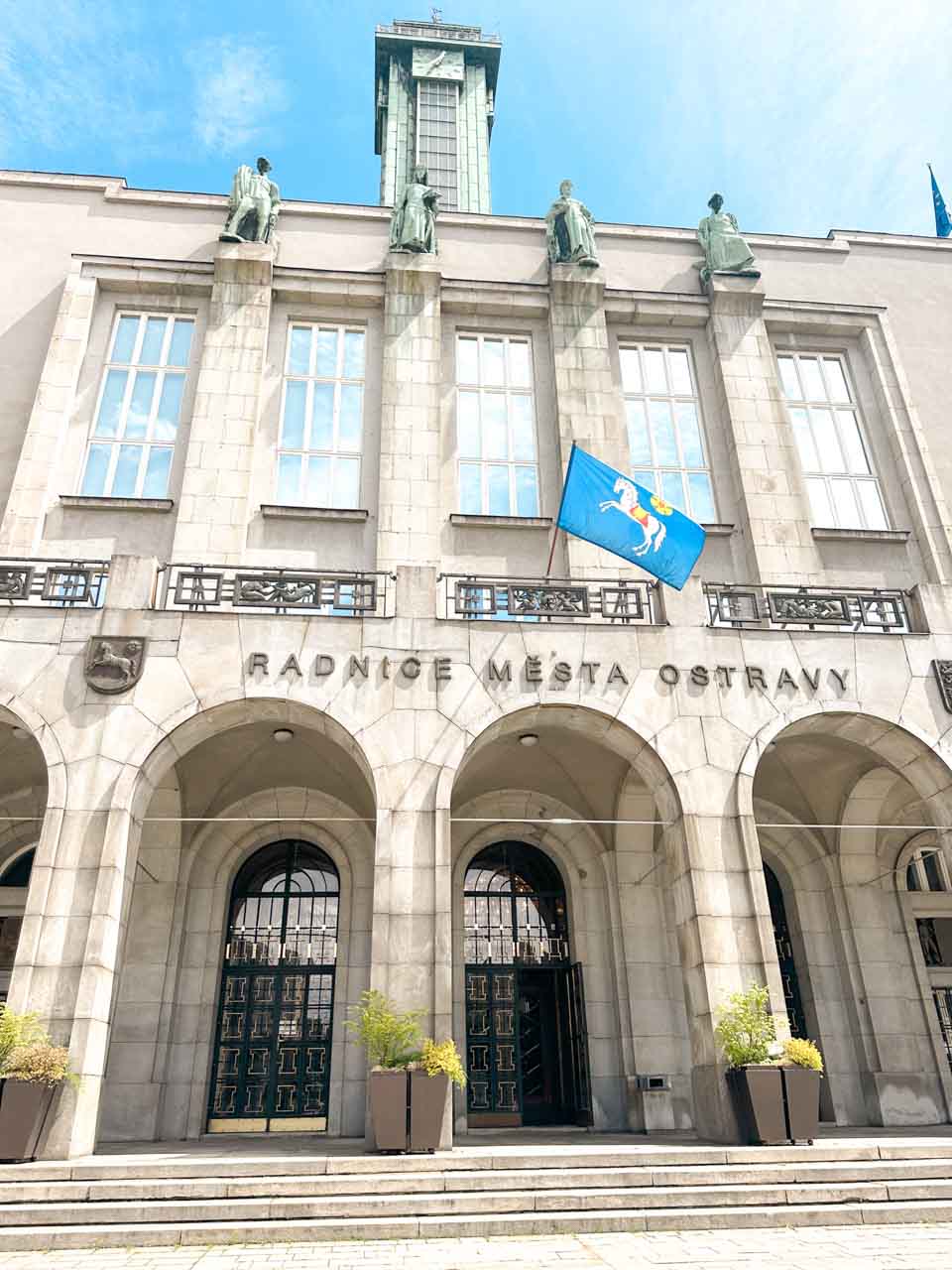 Front of the New City Hall in Ostrava with sculptures and a tall observation tower