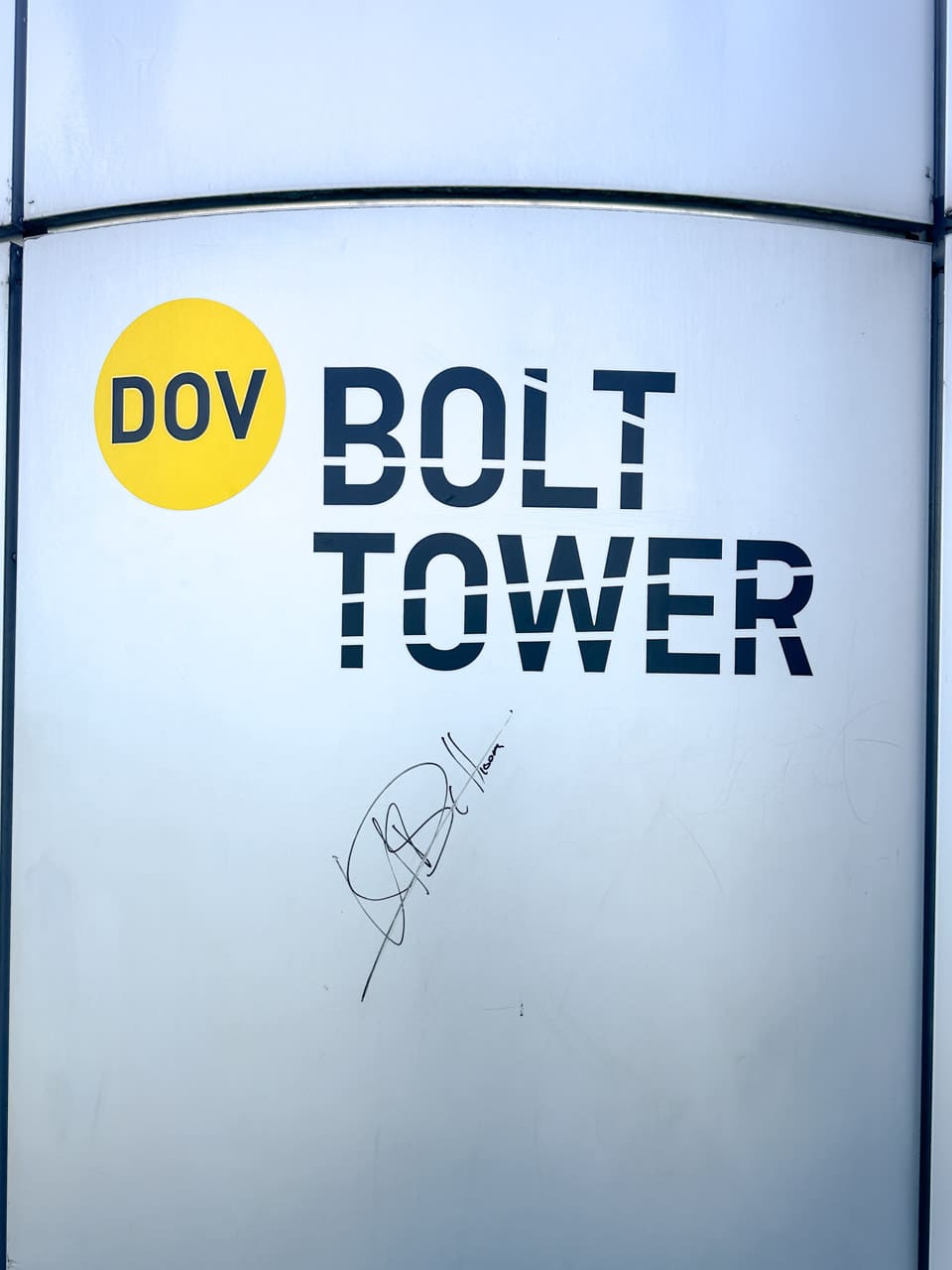 Close-up of a sign for Bolt Tower with Usain Bolt's autograph on it