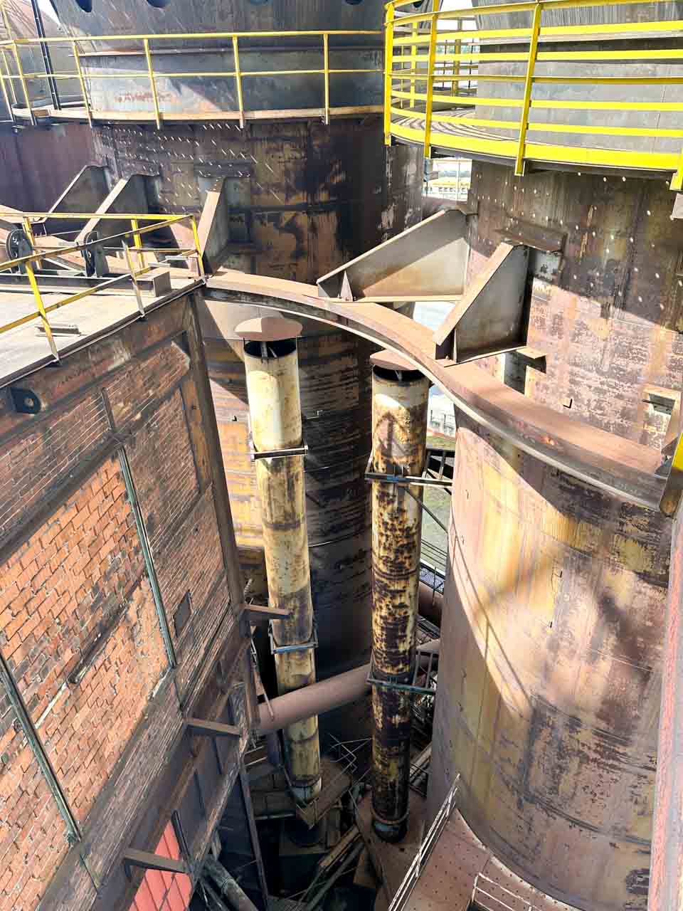 Close-up of rusty industrial machinery and pipes seen from the Bolt Tower