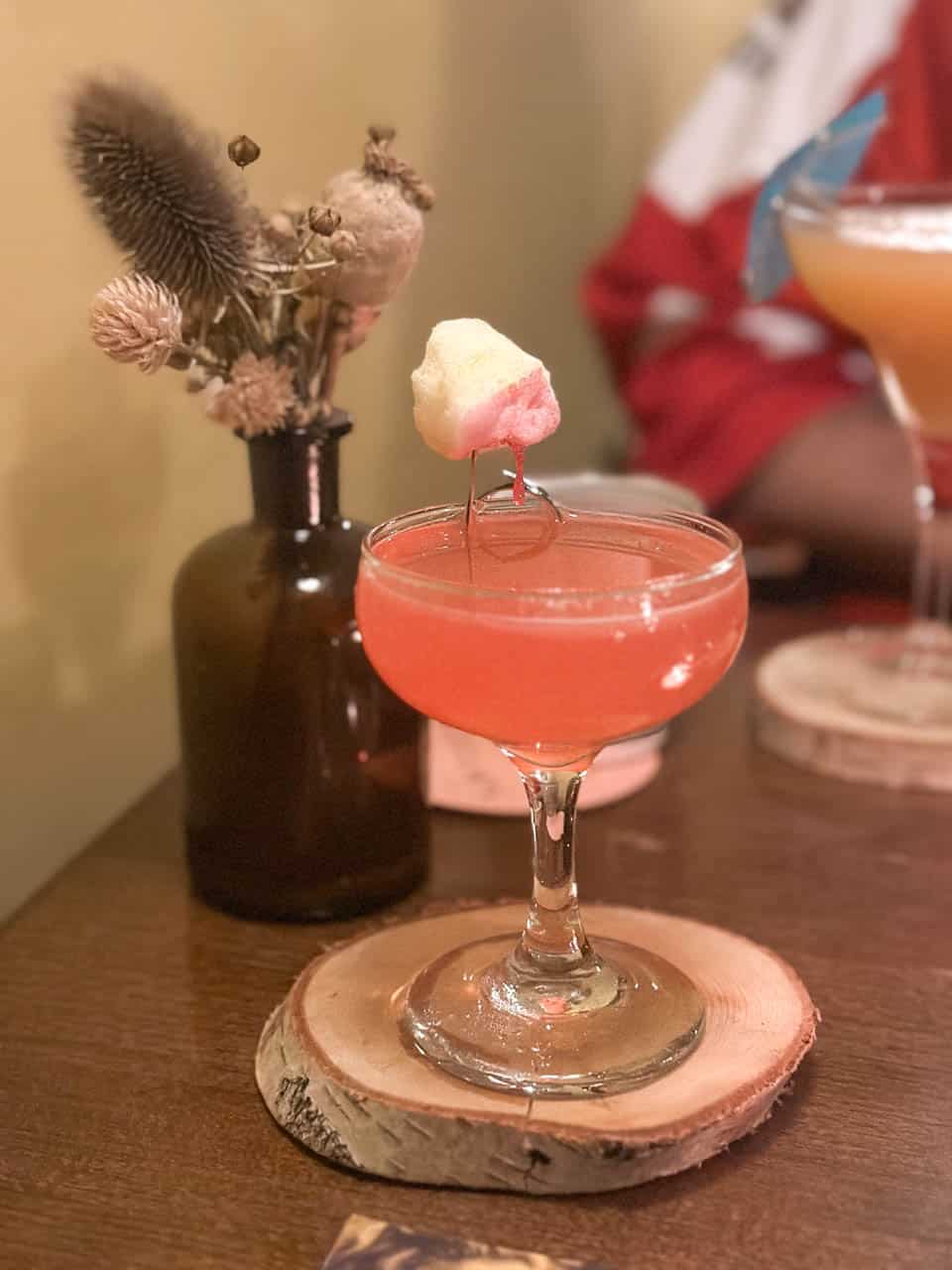 Close-up of a cocktail garnished with a fluffy marshmallow at the Modrá myš cocktail bar in Ostrava
