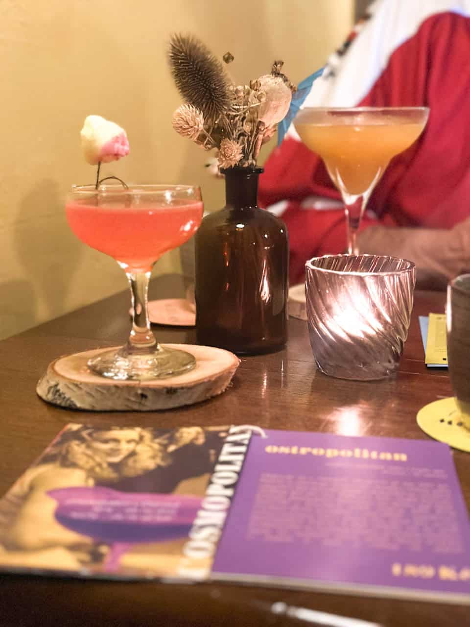 Two cocktails and an open menu on a table at the Modrá Myš cocktail bar in Ostrava