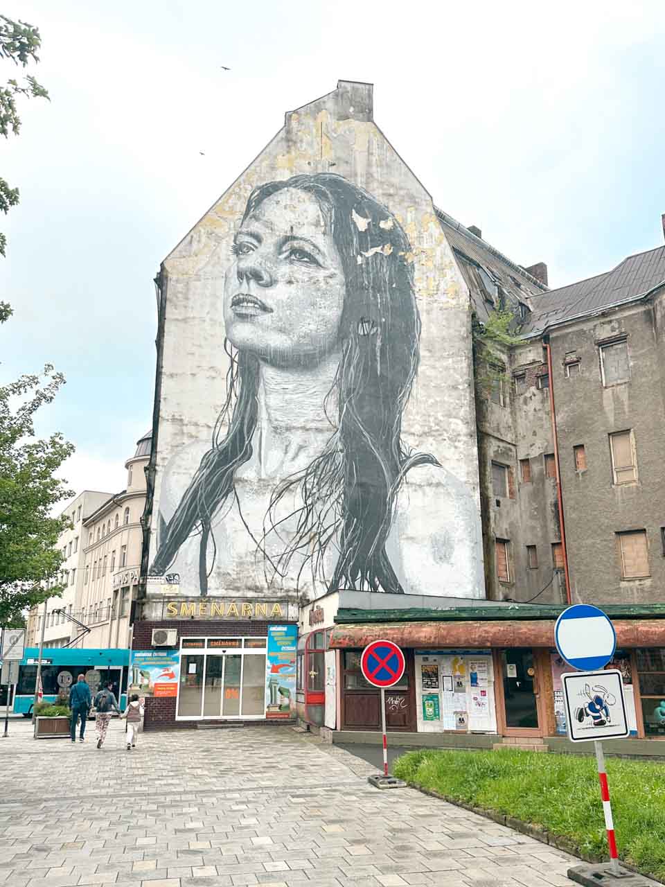 Large mural of a woman's face on an old building facade in Ostrava, called Ostravská Madona (Madonna of Ostrava)