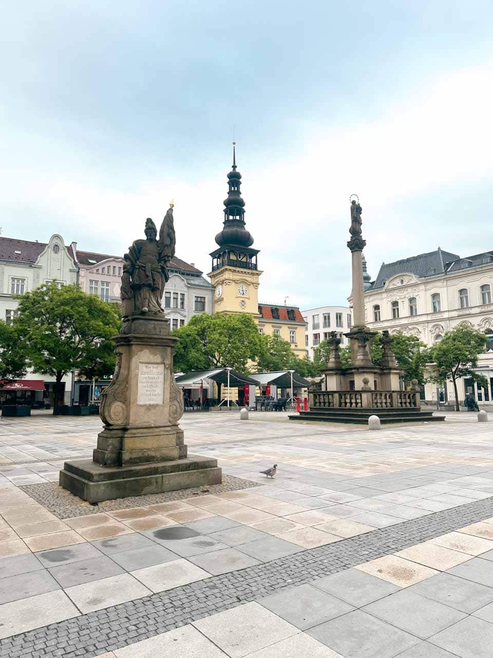 Masarykovo náměstí (Masaryk Square) in Ostrava with two statues and a clock tower in the background