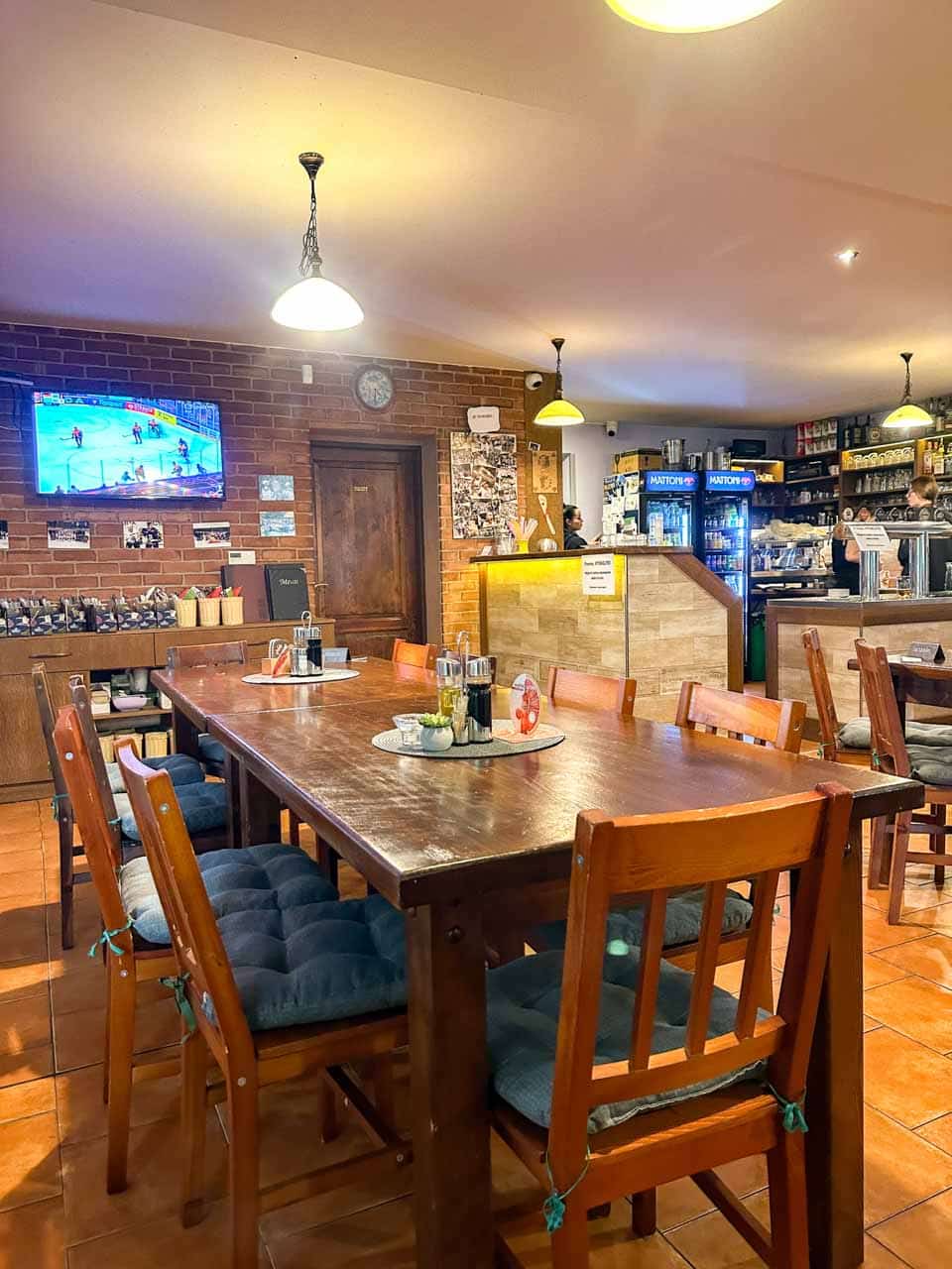 Interior of the Dáma Pyková Restaurant in Ostrava with brick walls and wooden tables