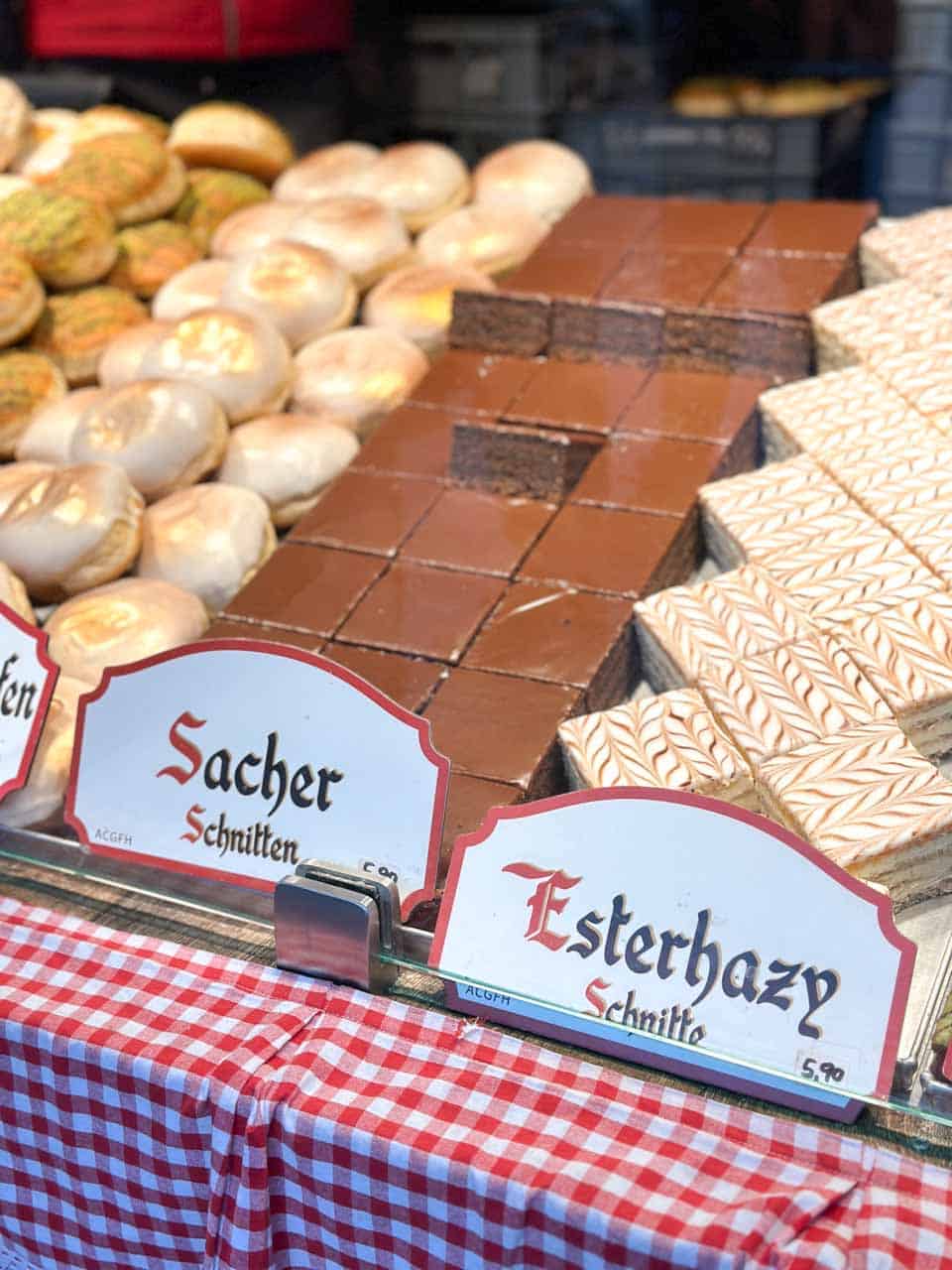 Sacher and Esterhazy slices displayed at a Christmas market stall in Vienna