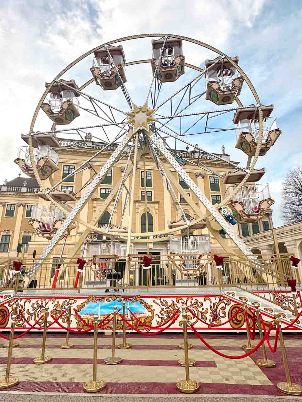 A vintage-style Ferris wheel in front of the Schönbrunn Palace in Vienna