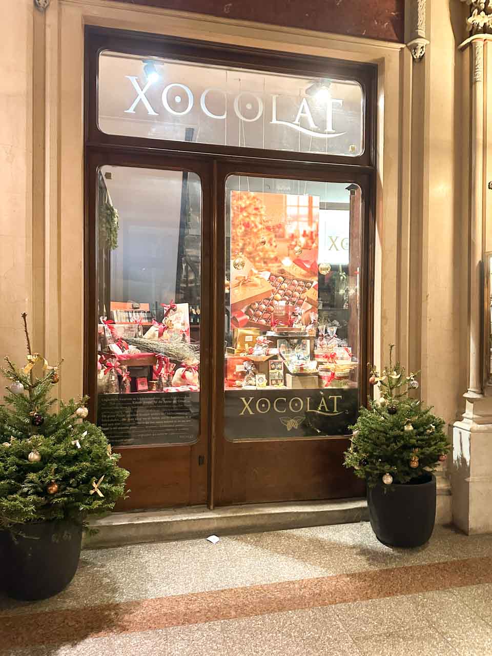 The Xocolat shop in Ferstel Passage, beautifully decorated with Christmas displays and small festive trees by the entrance