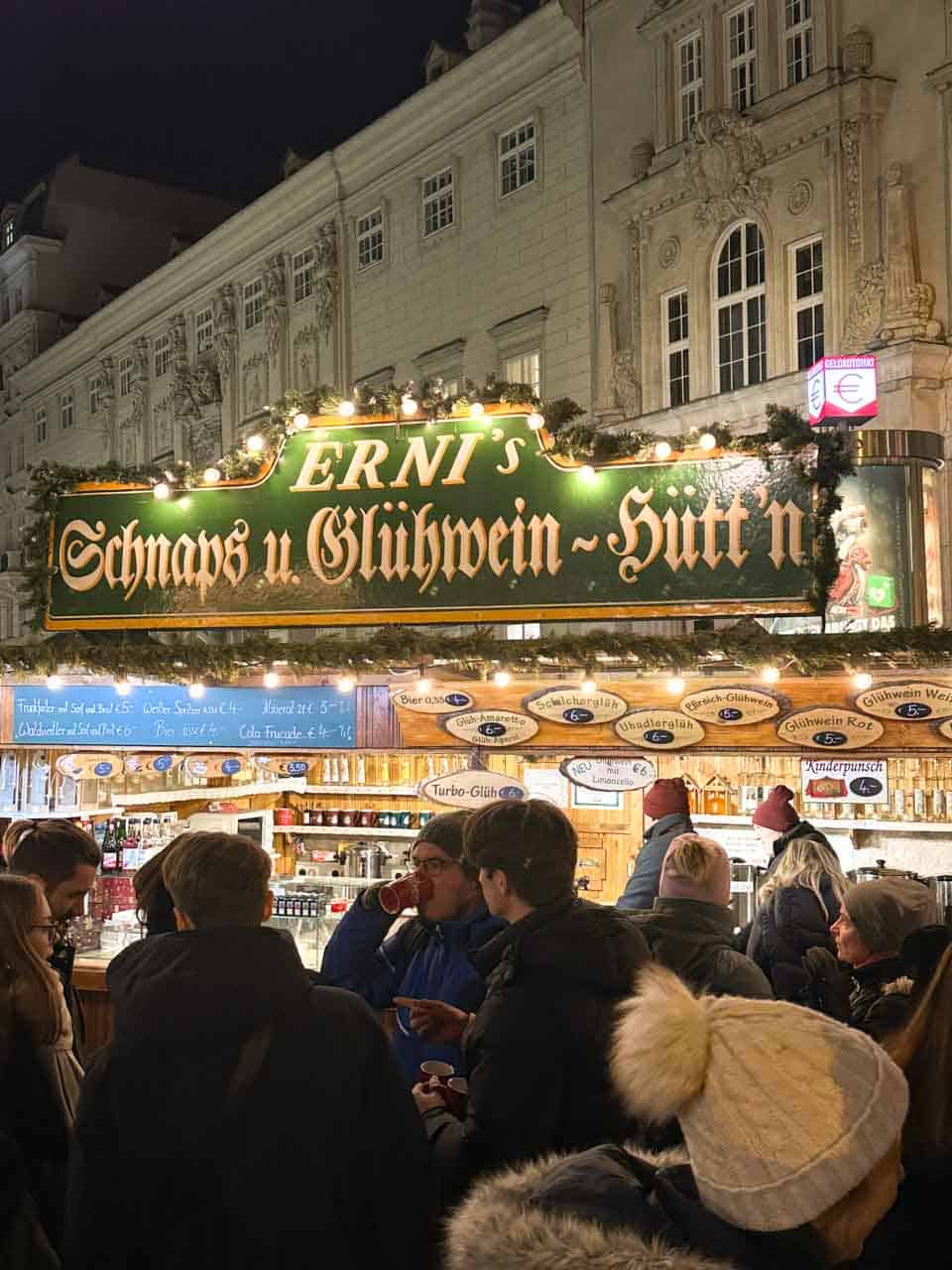 A busy Christmas market stall serving schnapps and mulled wine