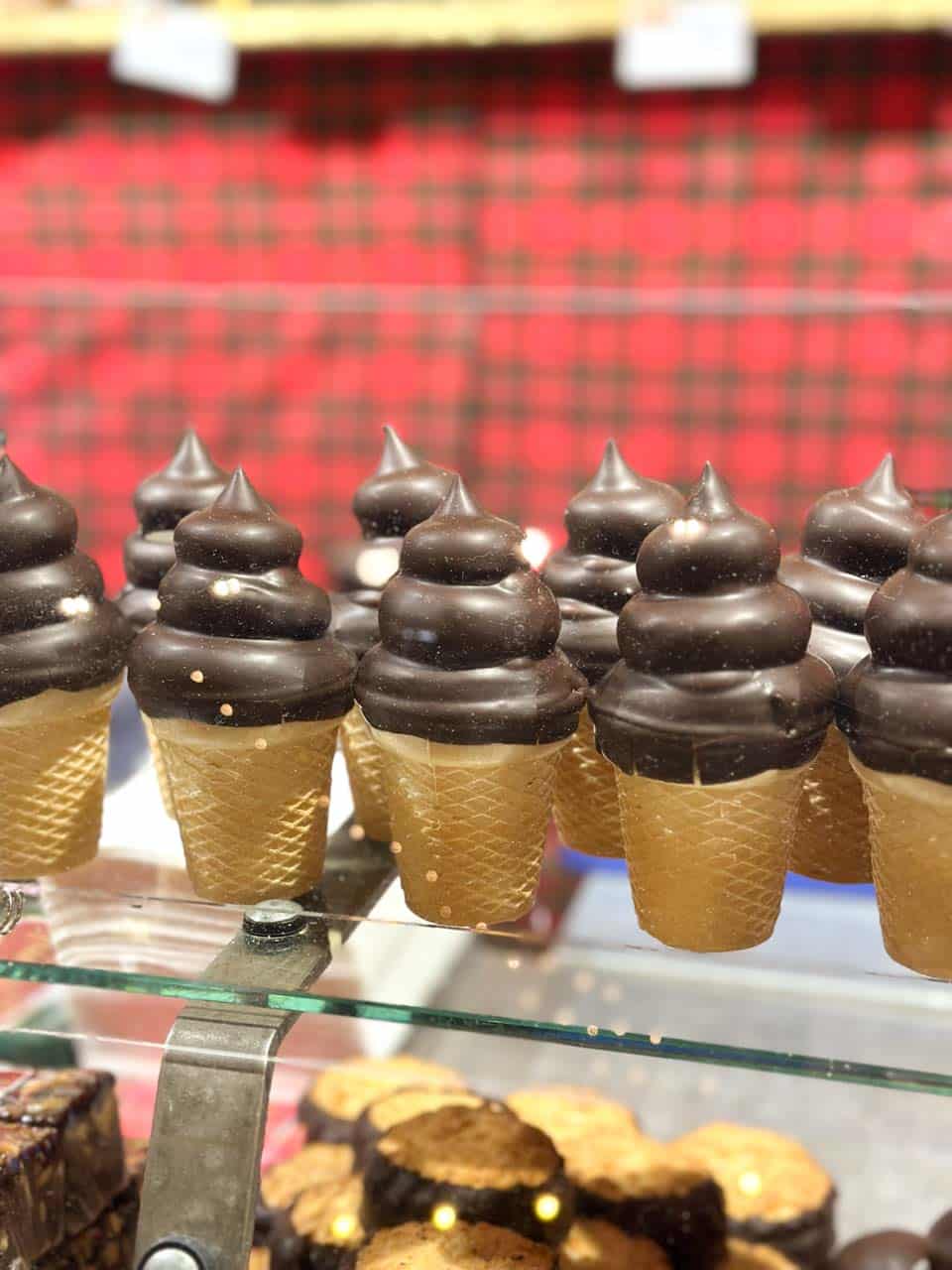 Chocolate-dipped marshmallow cones displayed in a glass case at the Weihnachtsmarkt am Hof Christmas market in Vienna