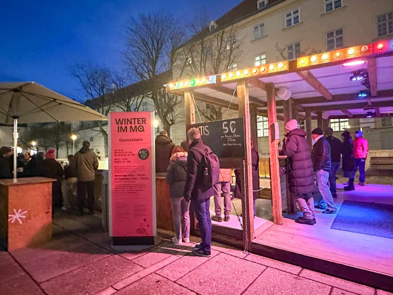 Visitors gathered around a curling rink at the Winter in MQ Christmas Market in Vienna