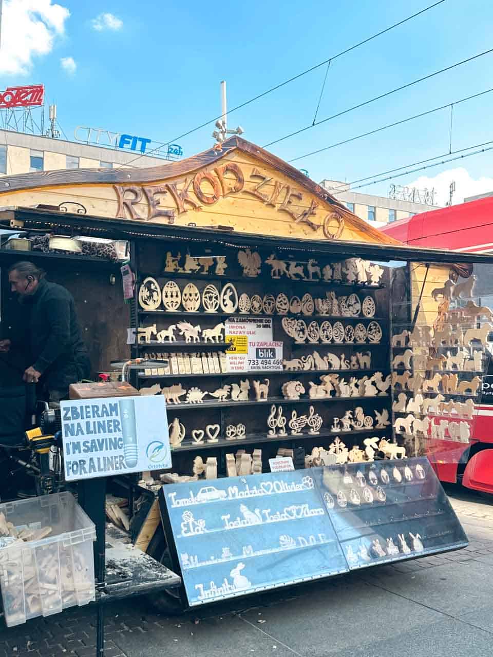 A wooden craft stall selling handmade Easter decorations, with shelves full of wooden cut-outs