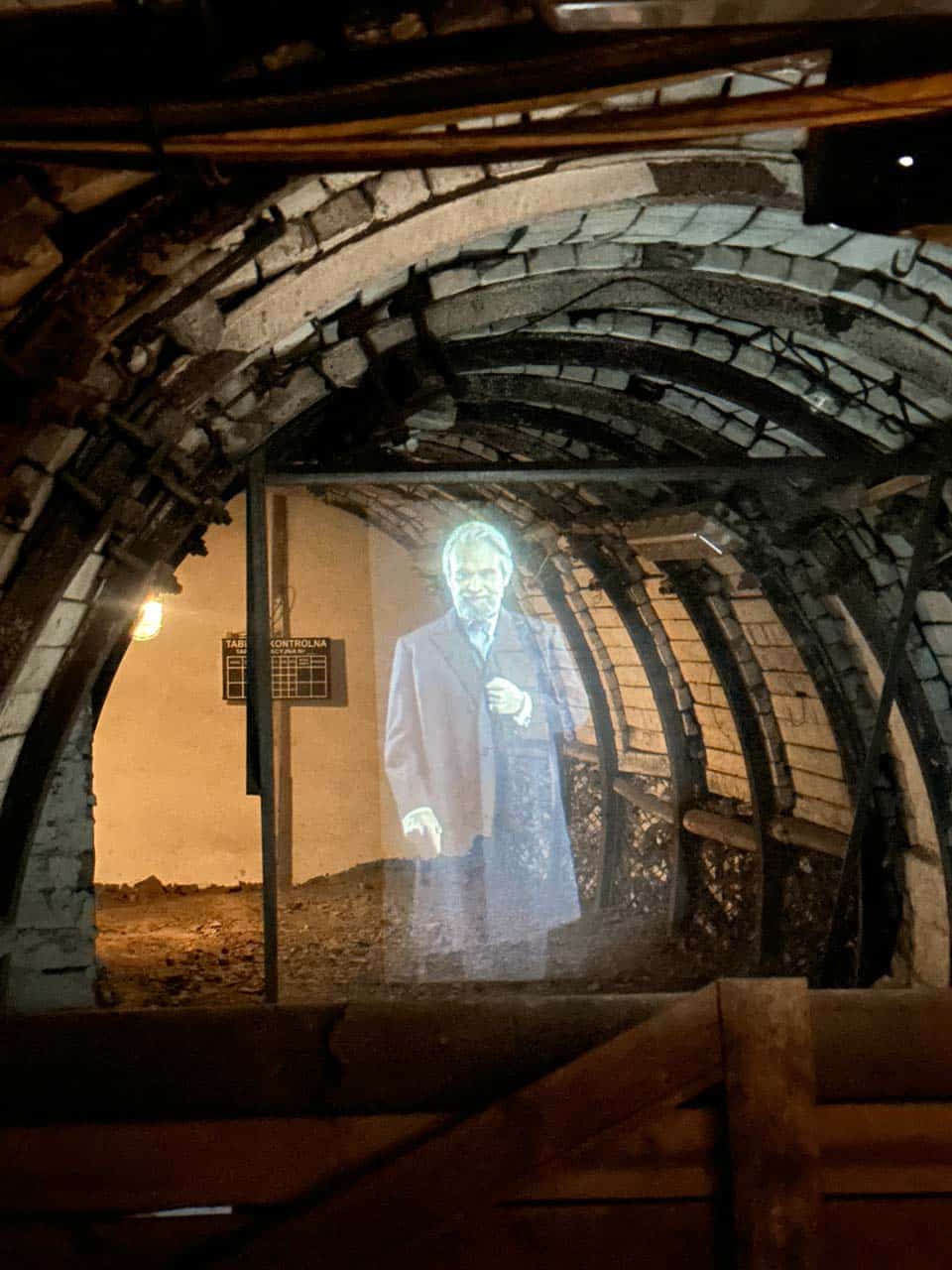 A ghostly hologram of a man projected in a dark underground mining tunnel at the Guido Mine in Zabrze, Poland