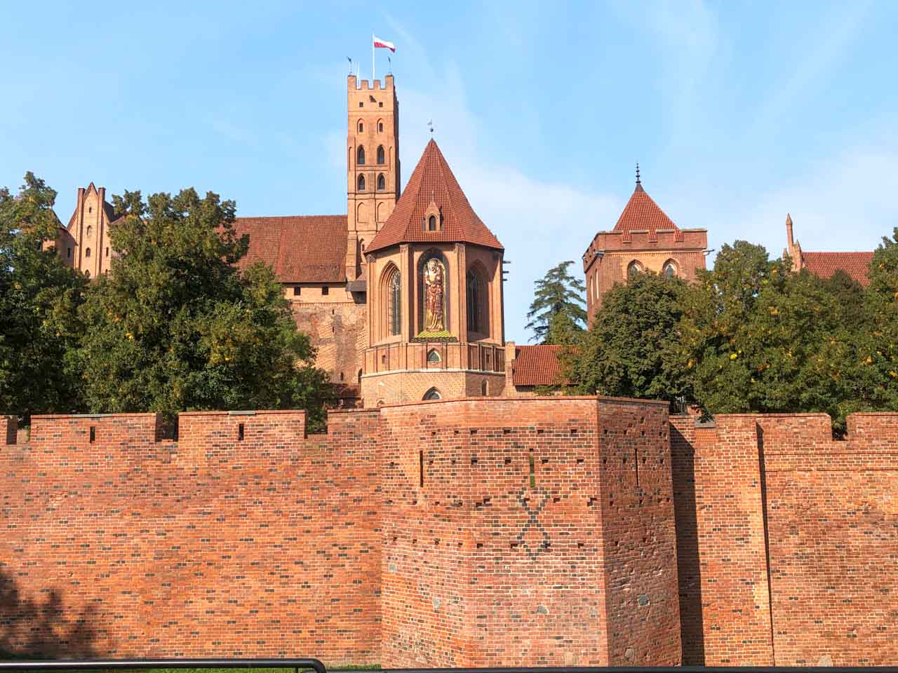 Malbork Castle seen from outside the walls, with the tall tower and Virgin Mary mosaic in view