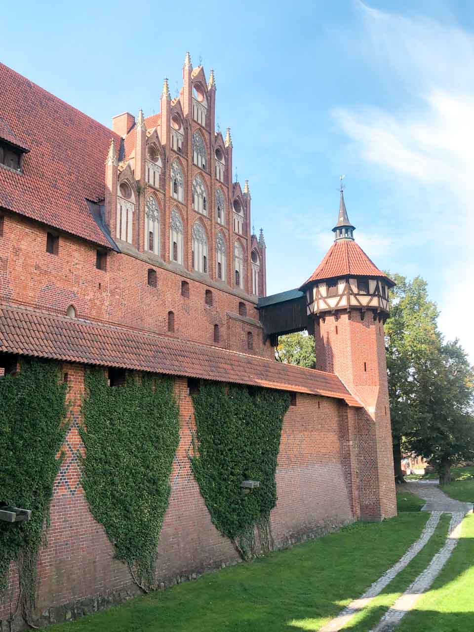 Decorative brick facade of Malbork Castle with pointed arches and tall windows