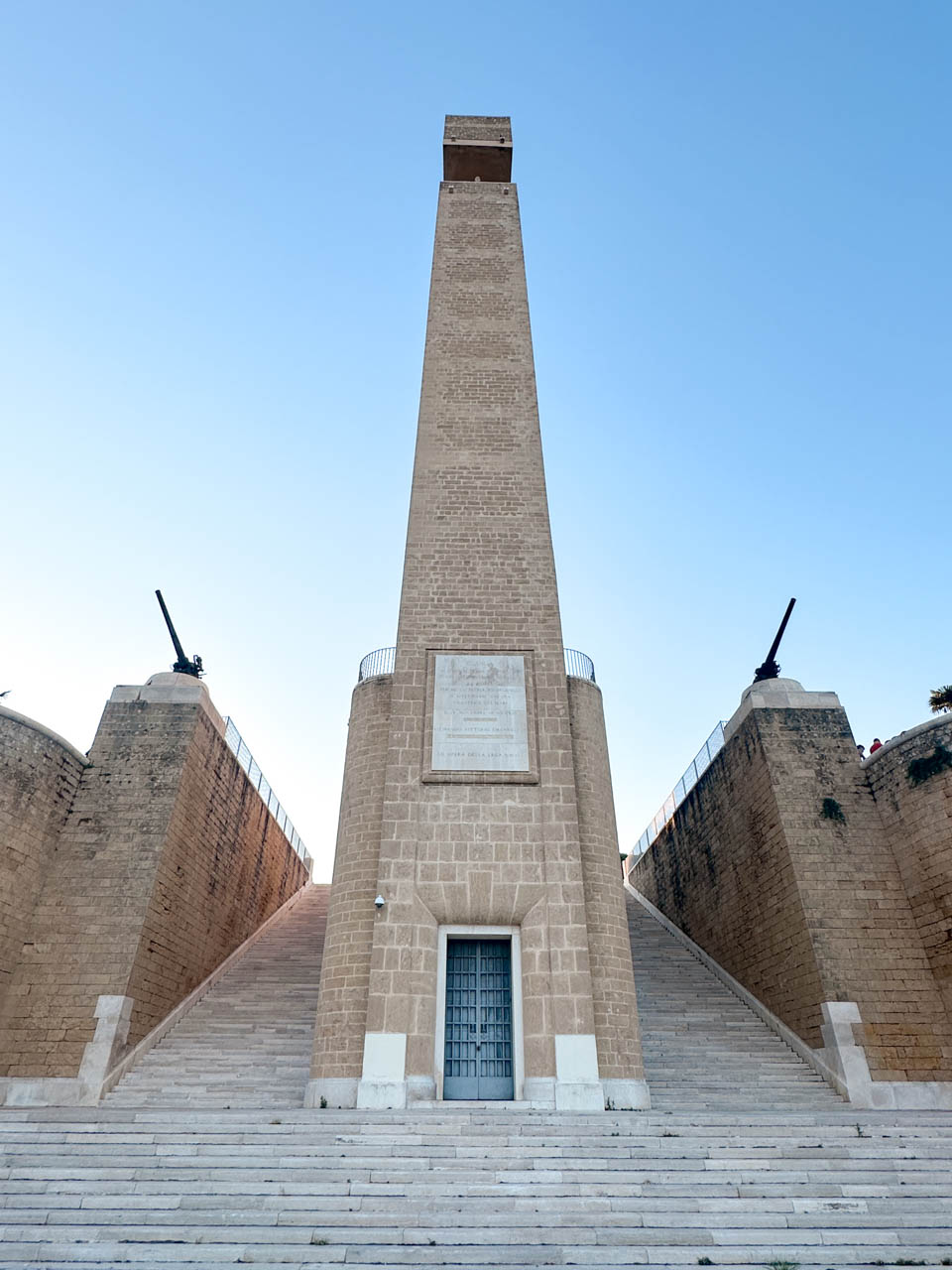 The Monument to the Italian Sailor in Brindisi, viewed from the front with steep steps and twin cannons