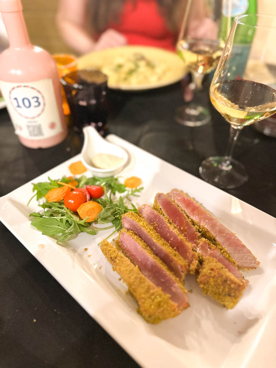 Sliced seared tuna in a crust, served with rocket, cherry tomatoes, and dipping sauce at La Locanda del Porto in Brindisi