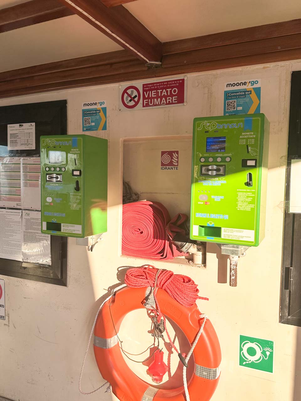 Ticket machines and a fire hose station on board a water taxi in Brindisi