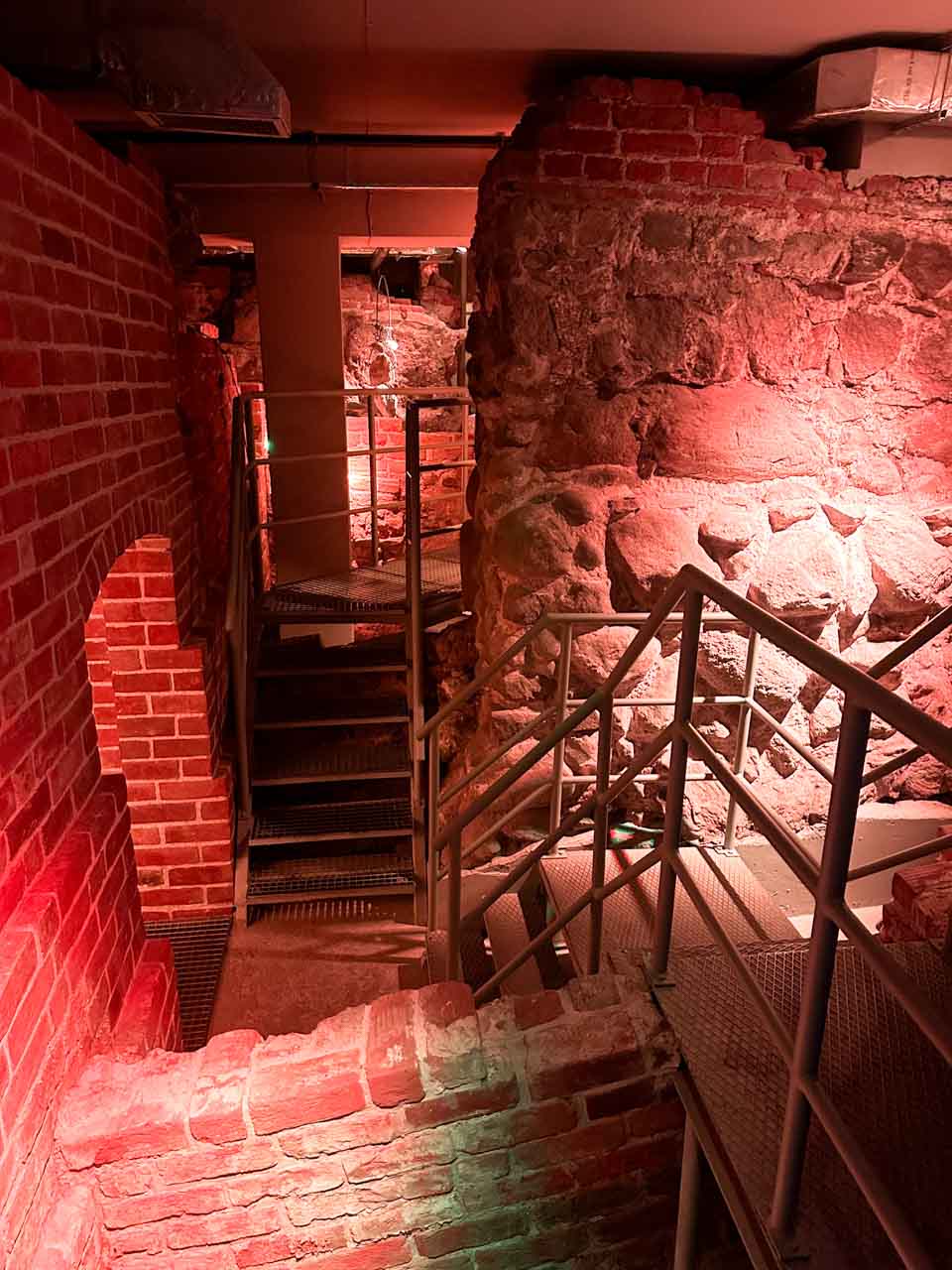 Metal staircase and brick walls inside the Romanesque Cellar in Gdańsk, Poland