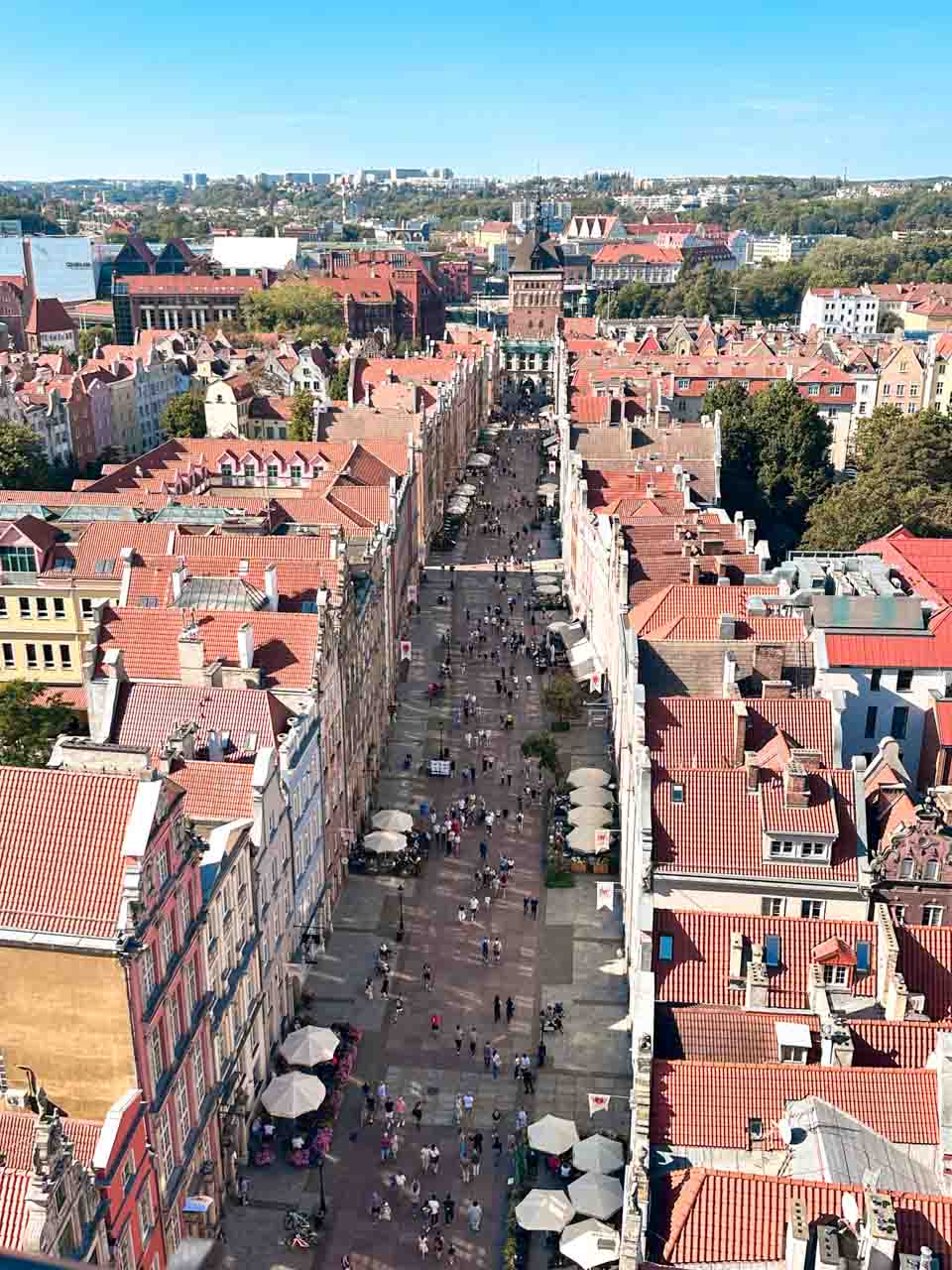 Long Market in Gdańsk seen from above, with people walking between colourful townhouses and cafés