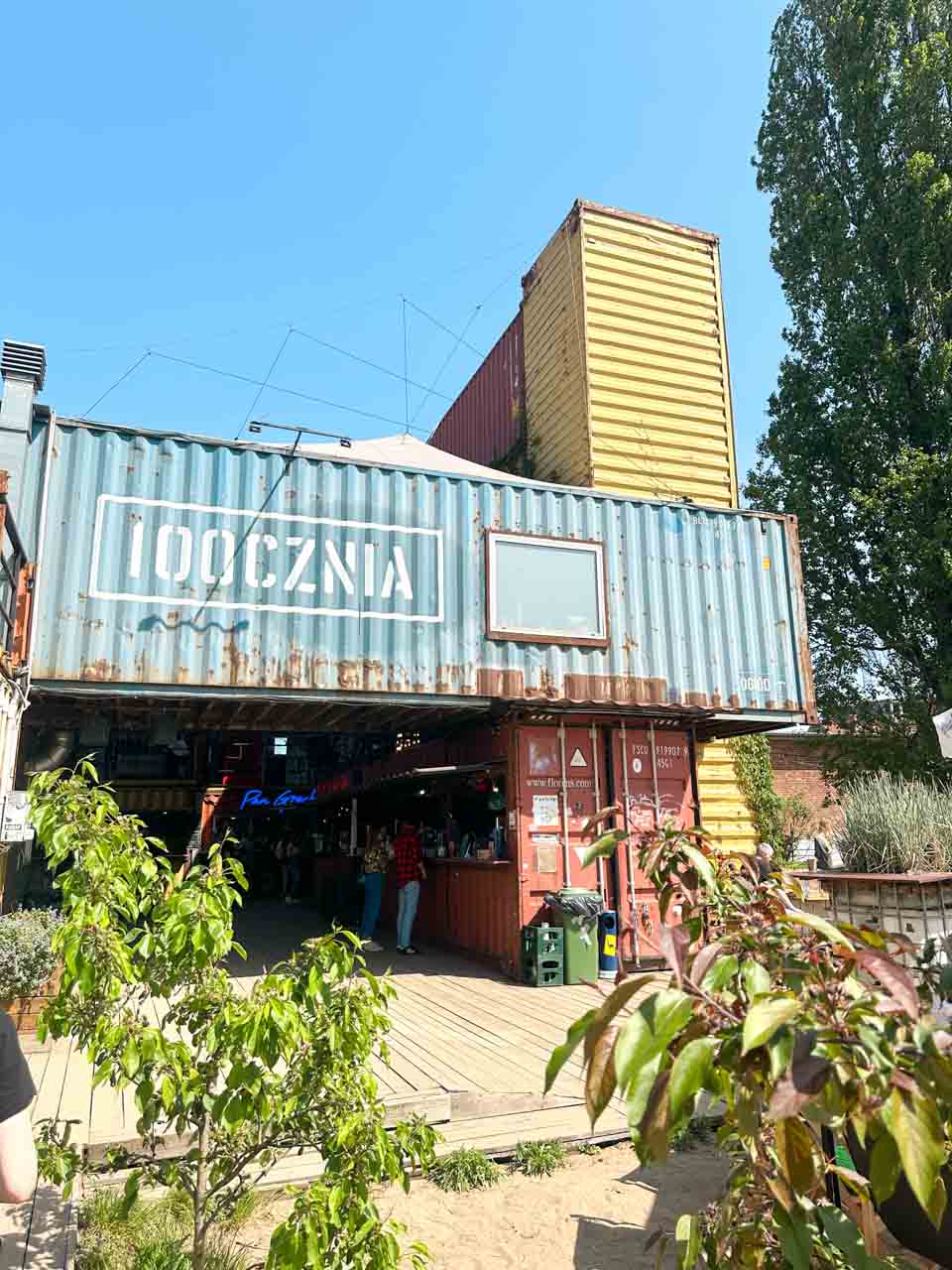 Entrance to 100cznia, a bar and cultural space made from stacked shipping containers in Gdańsk