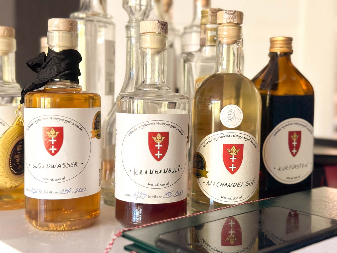 Bottles of traditional liqueurs including Goldwasser, Machandel Gin, and Kurfürsten on display