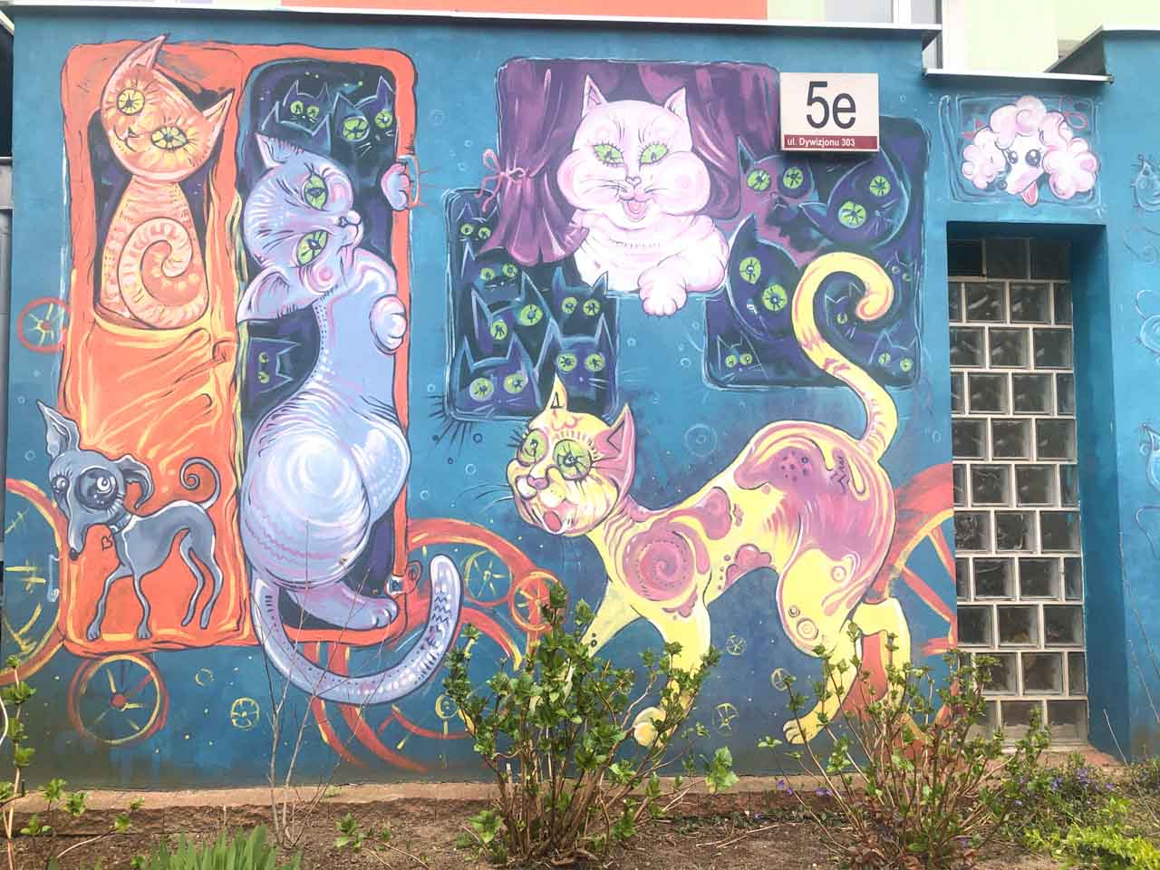 Colourful mural of whimsical cats and a dog painted on a residential building in Gdańsk’s Zaspa district