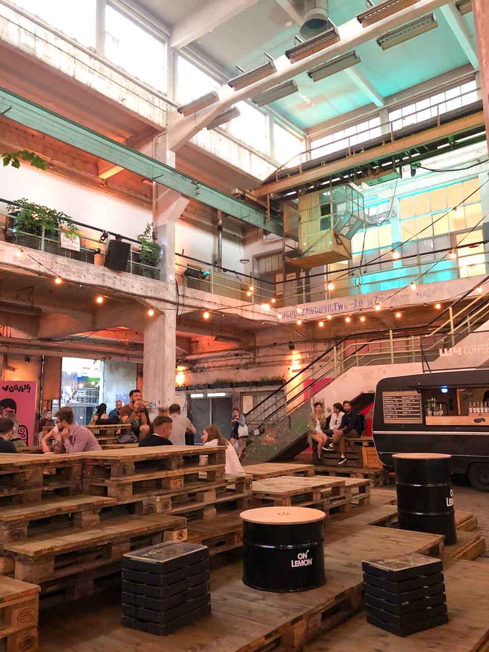 People chatting and drinking at W4 Food Hall on Elektryków Street