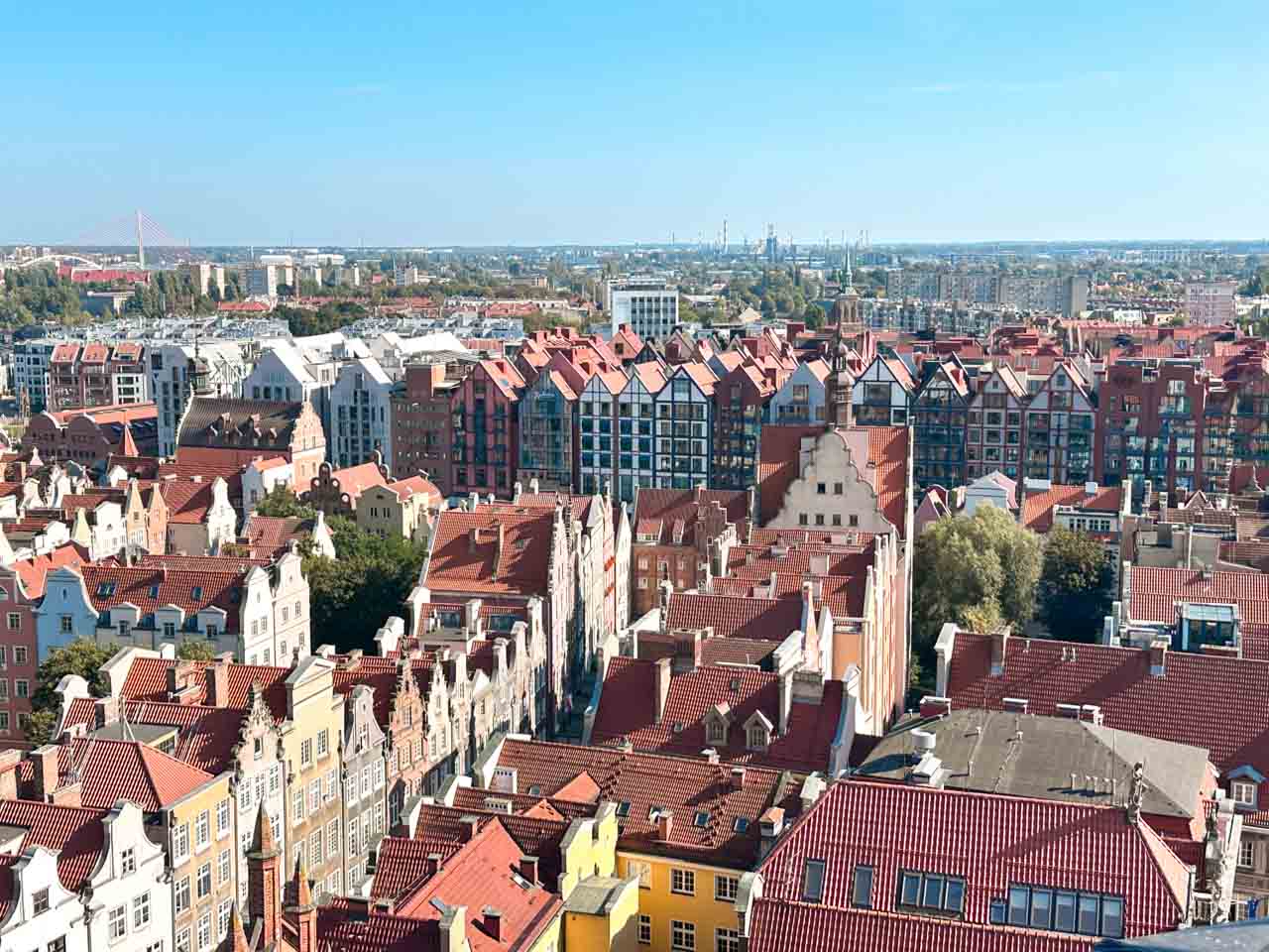 Panoramic view over colourful buildings with red-tiled rooftops in Gdańsk’s Main City