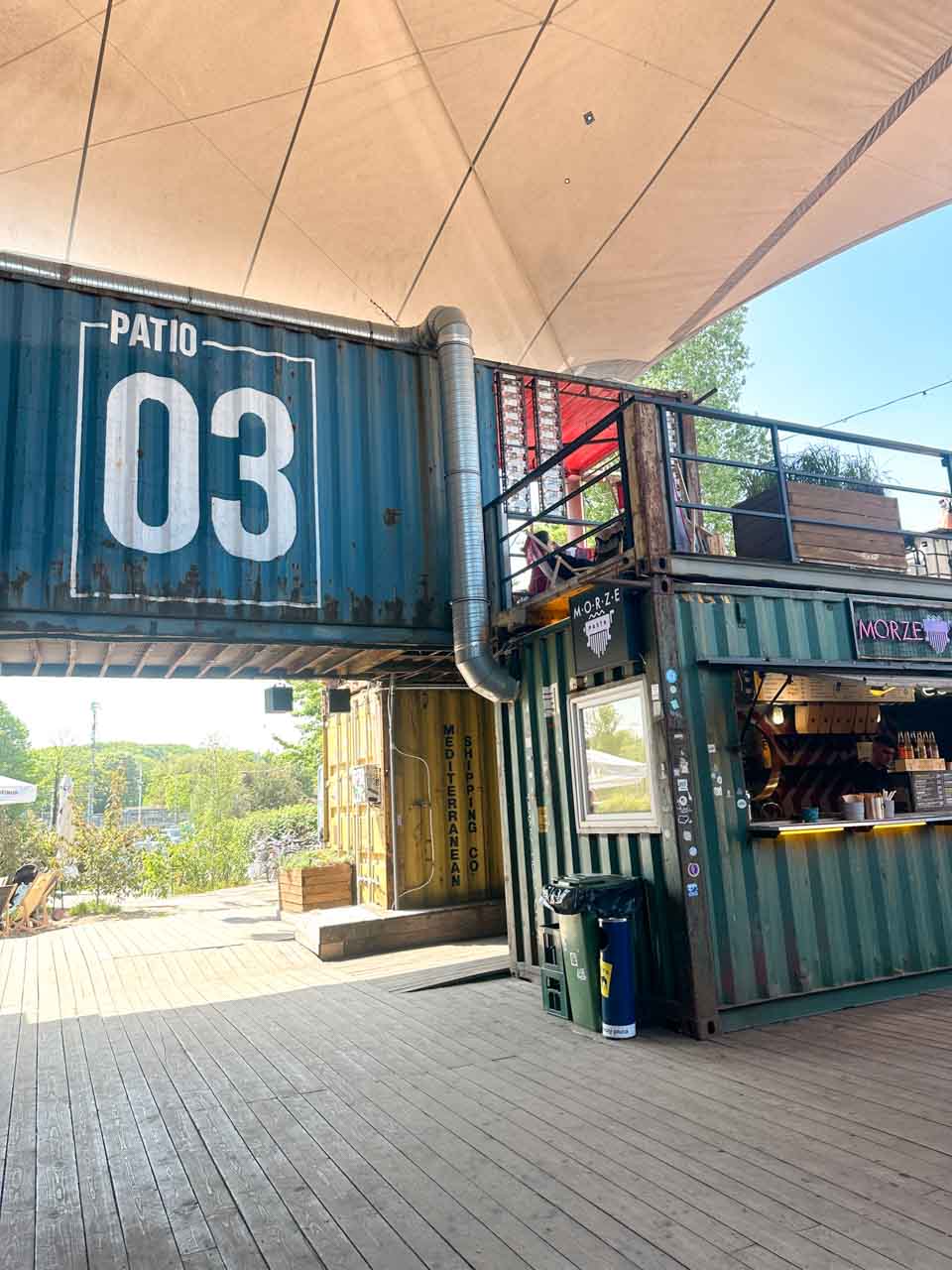 Shipping containers turned food stalls at Patio 03 in 100cznia, a creative space in the Gdańsk shipyard district