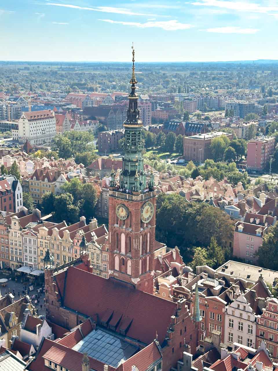 Close-up aerial view of the Main Town Hall’s tower with its green spire and twin clock faces