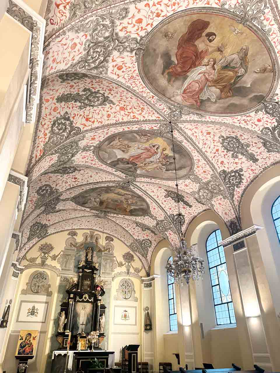 Baroque ceiling frescoes and ornate altar inside the Oliwa Cathedral in Gdańsk