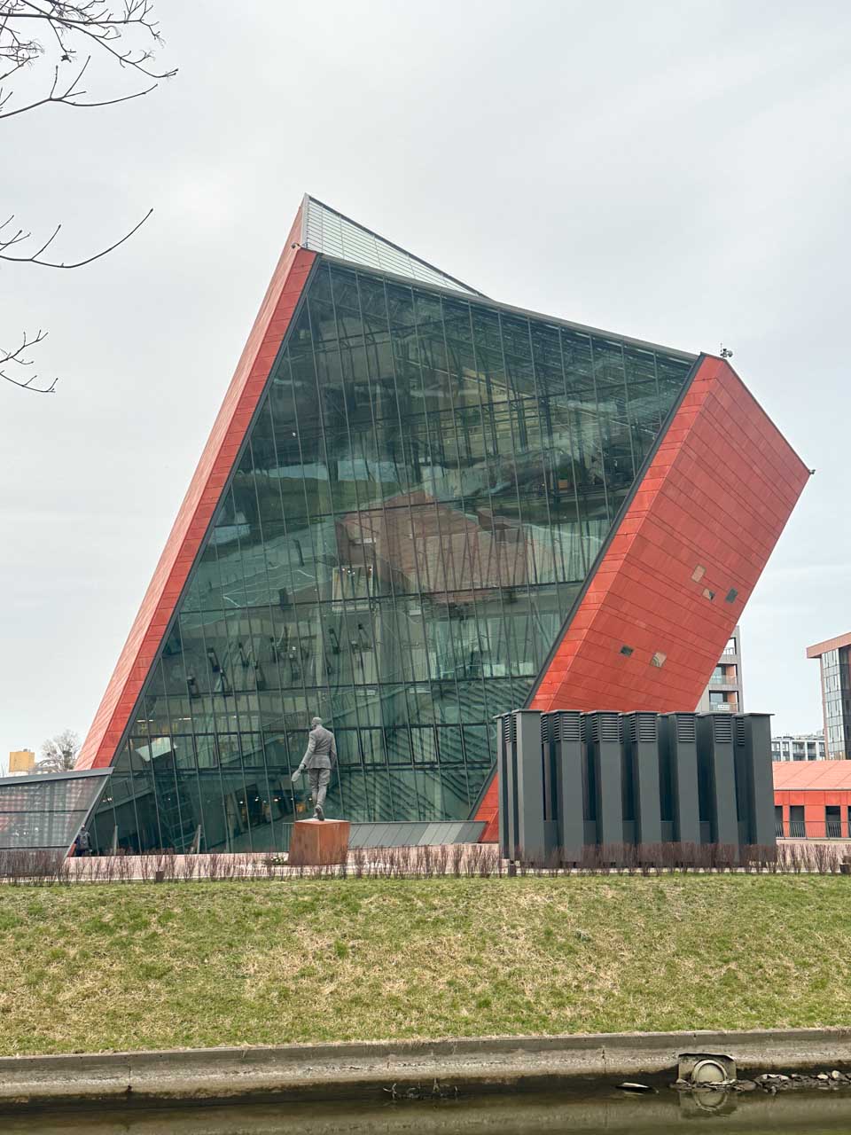 A red building with large glass panels housing the Museum of the Second World War in Gdańsk