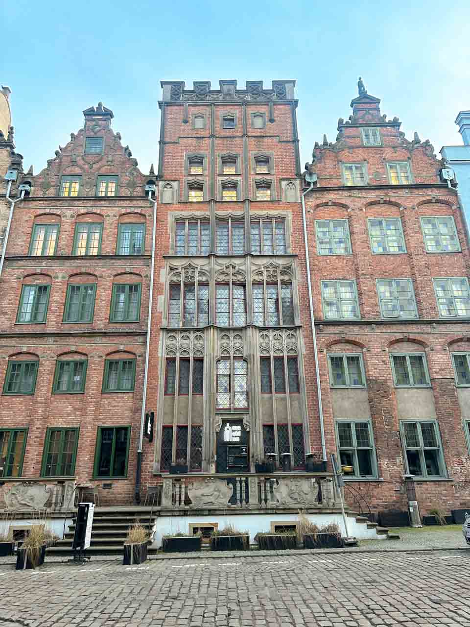 A row of tall brick townhouses on Chlebnicka Street in Gdańsk