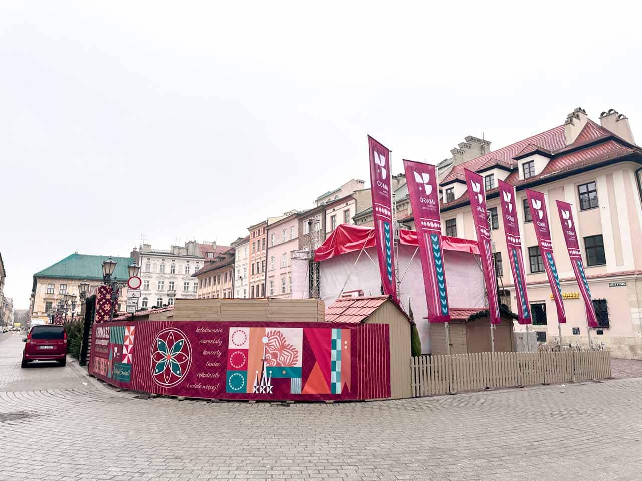 Colourful flags and decorative walls around the side entrance to the Christmas market on the Little Market Square in Krak&oacute;w, Poland
