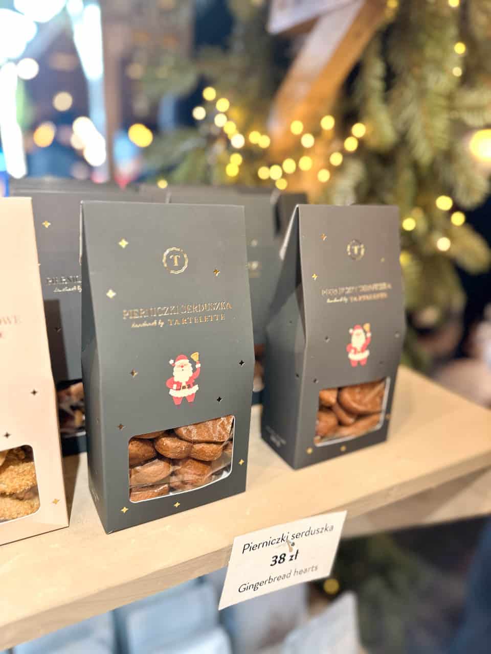 Gift boxes of gingerbread hearts with a clear window and a Santa illustration on display at the Krak&oacute;w Christmas market