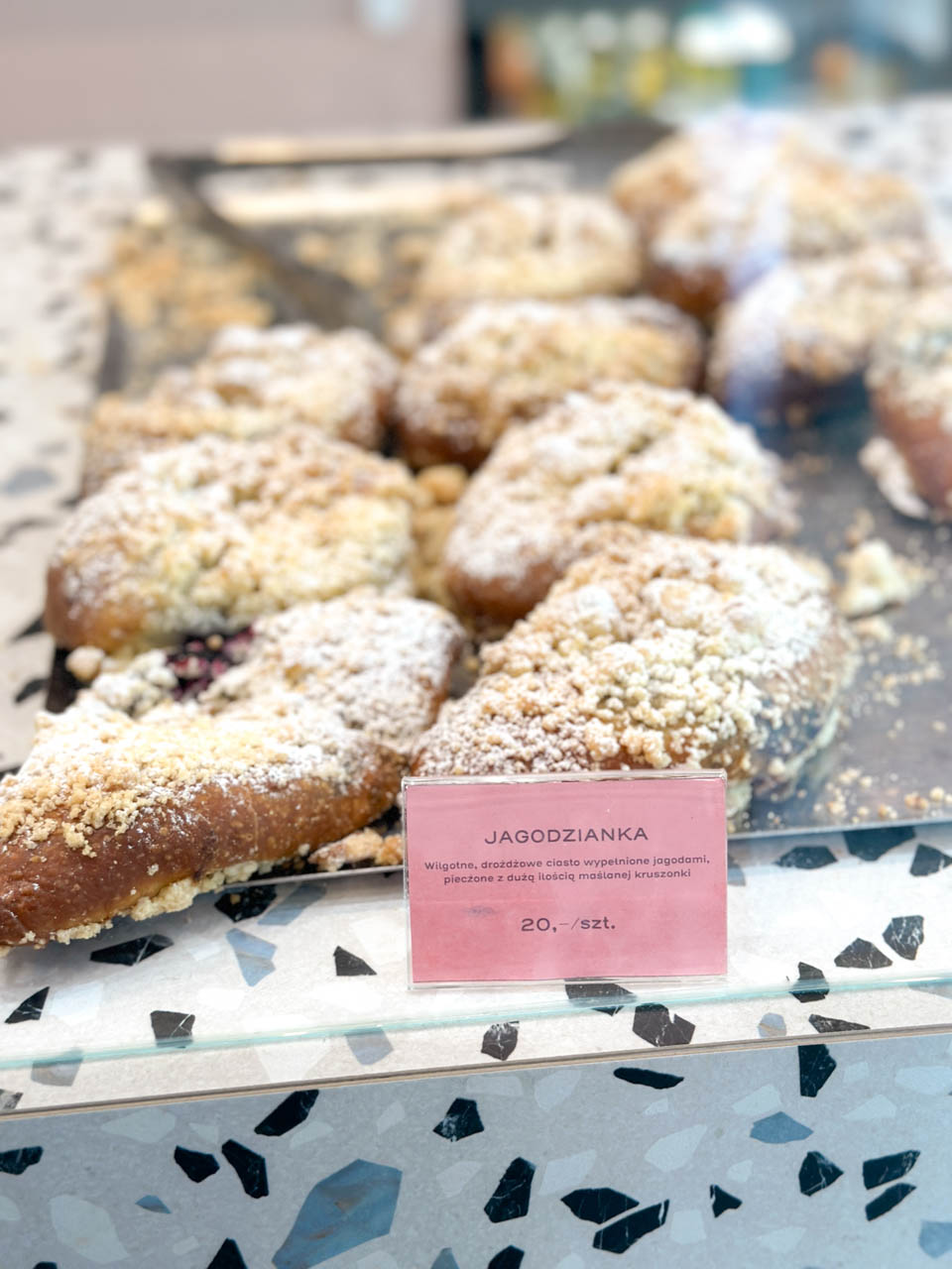 Close-up of jagodzianki, bilberry buns with crumble topping, at Must Bake in Gdańsk
