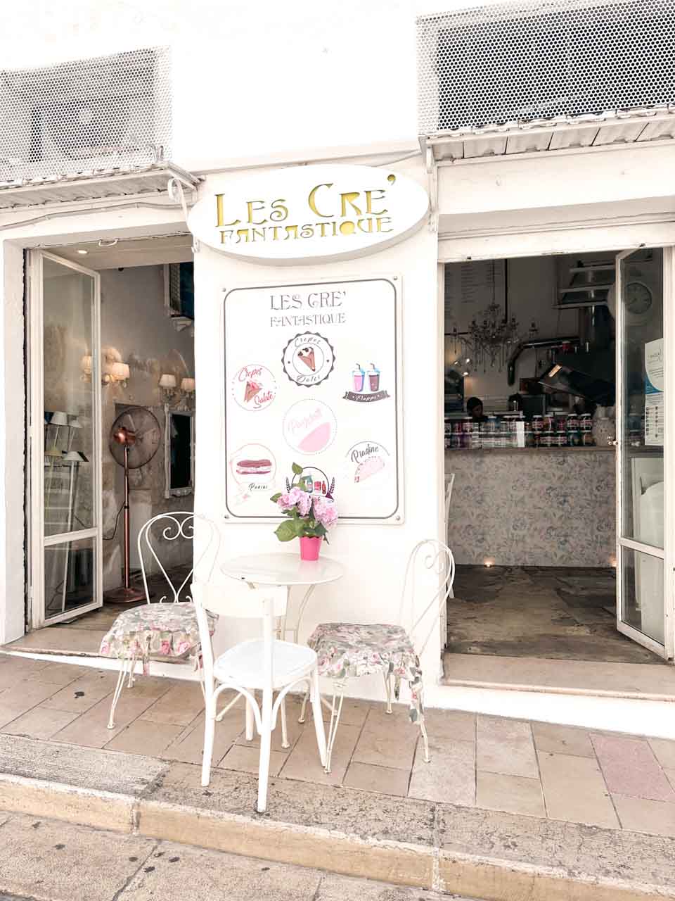 Floral chairs and a table outside Les Cr&ecirc; Fantastique in Ostuni, Italy