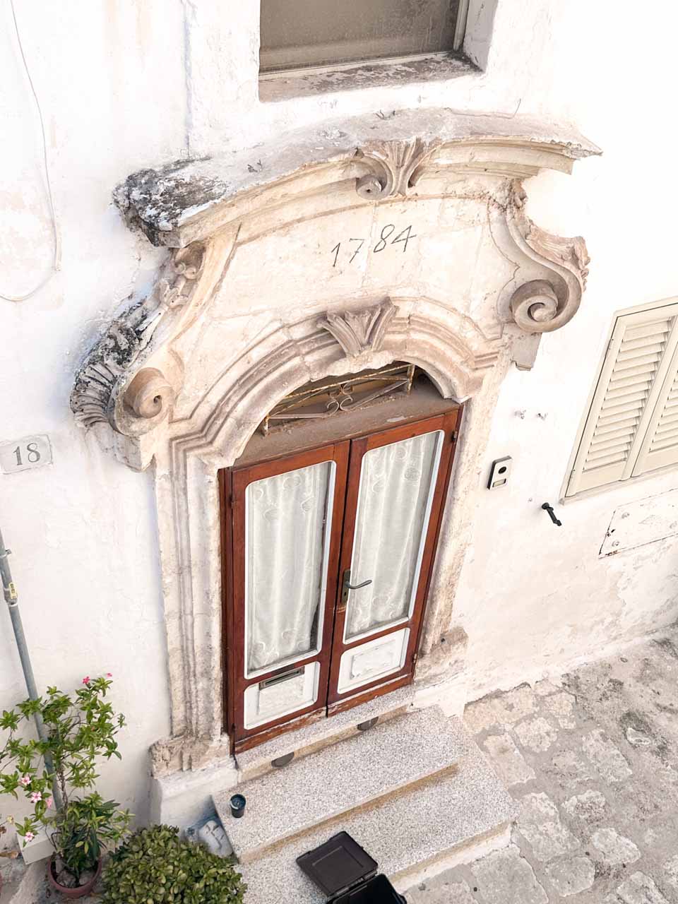 Ornate stone doorway dated 1784 with carved details in Ostuni&rsquo;s historic centre