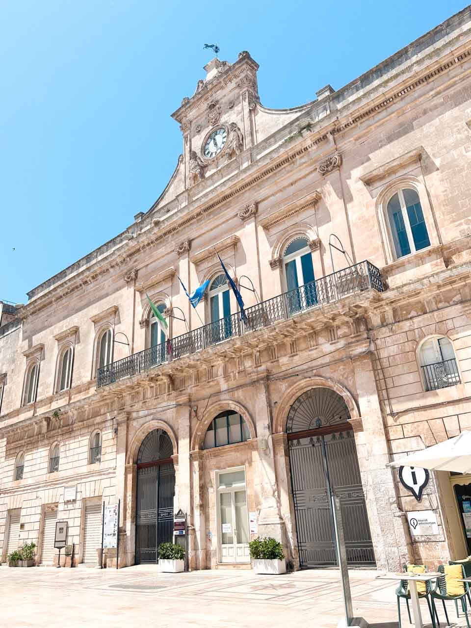 Town hall building with a clock tower and balconies in Ostuni, Italy