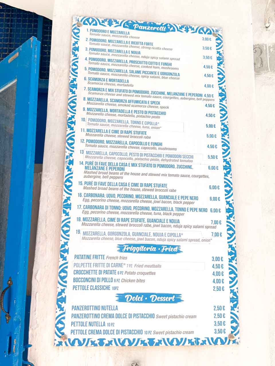 Panzerotti menu board with prices displayed outside Asso di Spade in Ostuni, Italy