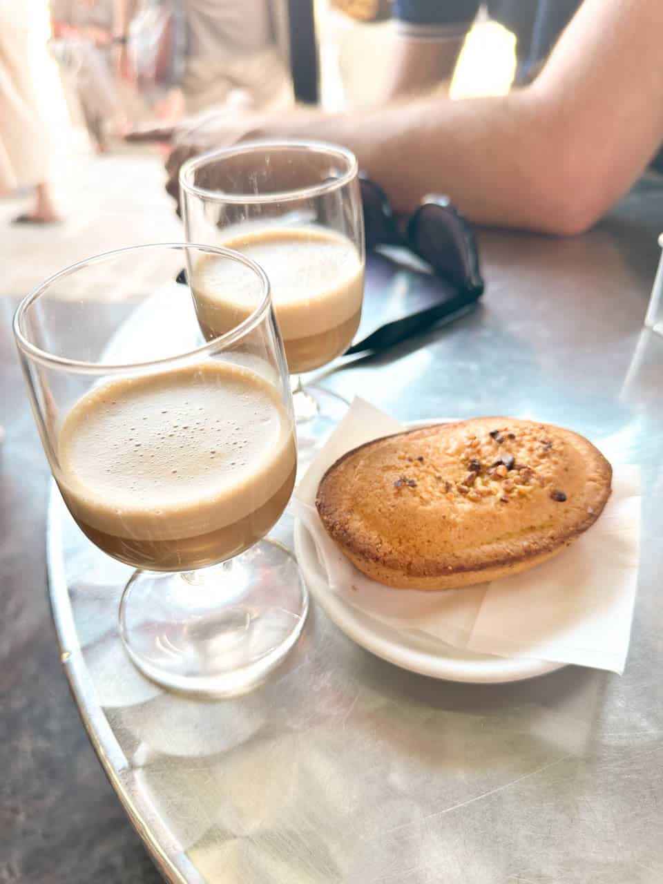 Two glasses of caffe speciale with a pasticciotto on a plate at The Super Mago del Gelo Mario Campanella in Polignano a Mare